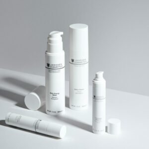 A minimalistic display of skincare bottles showcasing Janssen Cosmetics with a clean white backdrop.