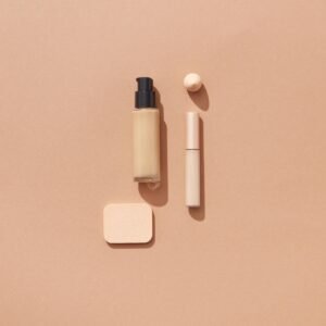 Flat lay of beauty products on a brown background with space for text, ideal for cosmetic promotions.
