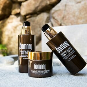 High-end skincare products displayed outdoors, featuring revitalizing toner and brightening booster.